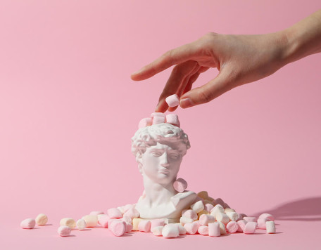 ancient head with marshmallow and female hand on p 2023 11 27 05 19 53 utc